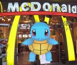 Pokemon Go character stands in front of a McDonald's arches in virtual game.