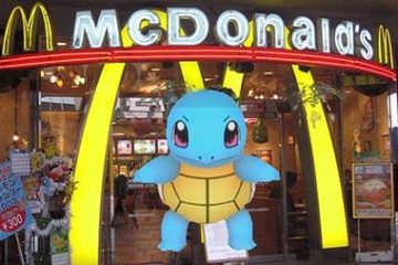 Pokemon Go character stands in front of a McDonald's arches in virtual game.