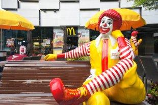 Statue of Ronald McDonald sits on a bench outside of a McDonald's in Bangkok, Thailand.