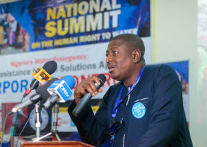 Bode Oluwafemi, deputy director of Environmental Rights Action/Friends of Nigeria, addresses attendees at the National Water Summit in Abuja, Nigeria. CREDIT: BABAWALE OBAYANJU