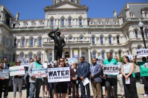 A crowd of activists and councilmembers gathers in Baltimore to call for the passage of the Water Accountability and Equity Act.