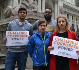 Corporate Accountability organizers stand up to PMI at its annual shareholders meeting, and hold signs outside the NYC public library.