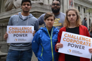 Corporate Accountability organizers stand up to PMI at its annual shareholders meeting, and hold signs outside the NYC public library.