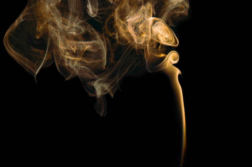 Smoke rising against a black background
