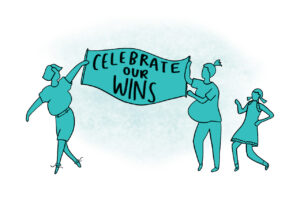 Three people holding a sign that reads “Celebrate our wins” in bold, capital letters. They are in mid-conversation as they walk.