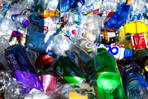 A heap of plastic drink bottles and soda cans.