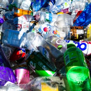 A heap of plastic drink bottles and soda cans.
