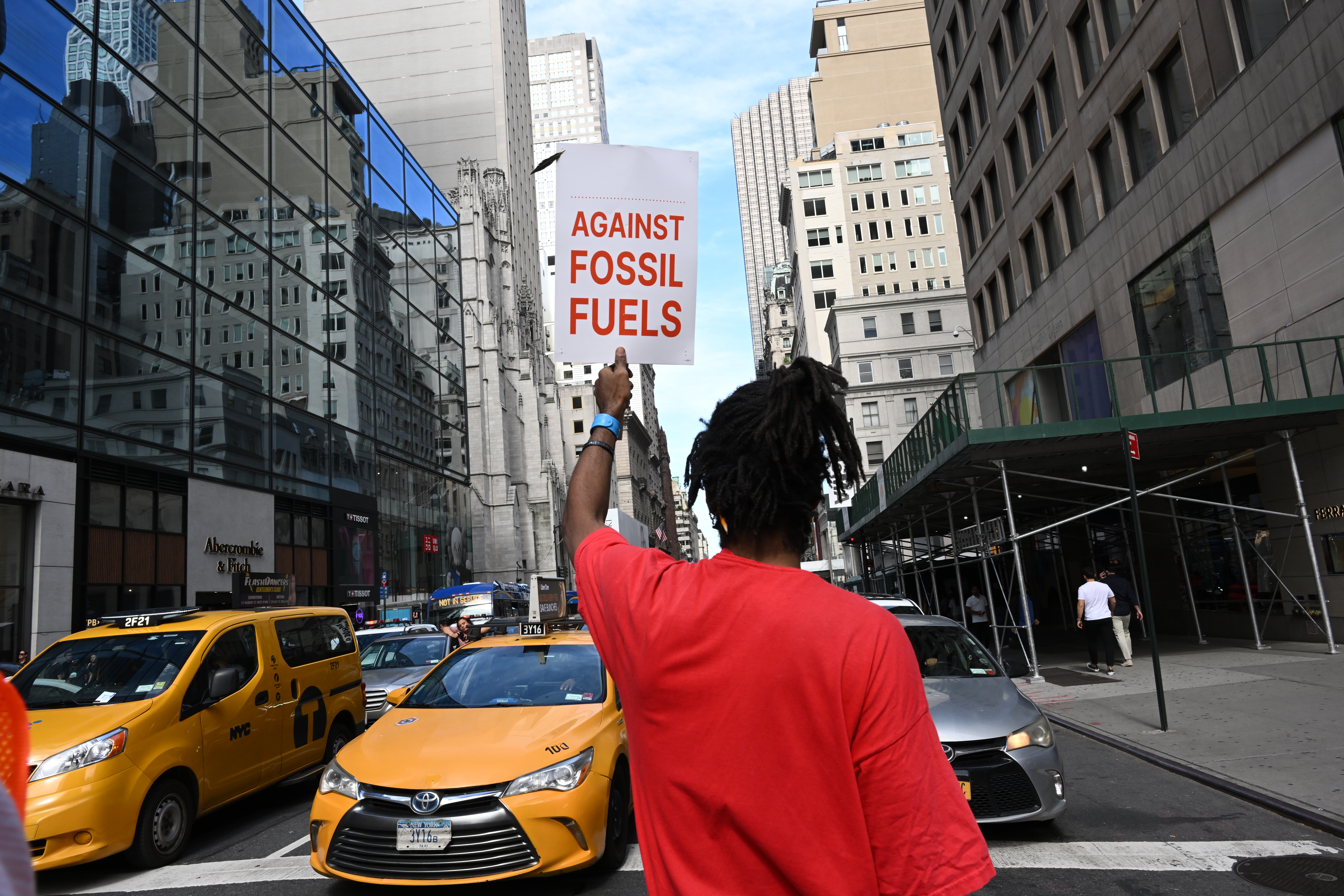 A person holds up a sign "against fossil fuels" during Climate Week in New York City.