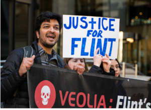 Organizers lead action in city, holding banners and signs that read Justice for Flint.